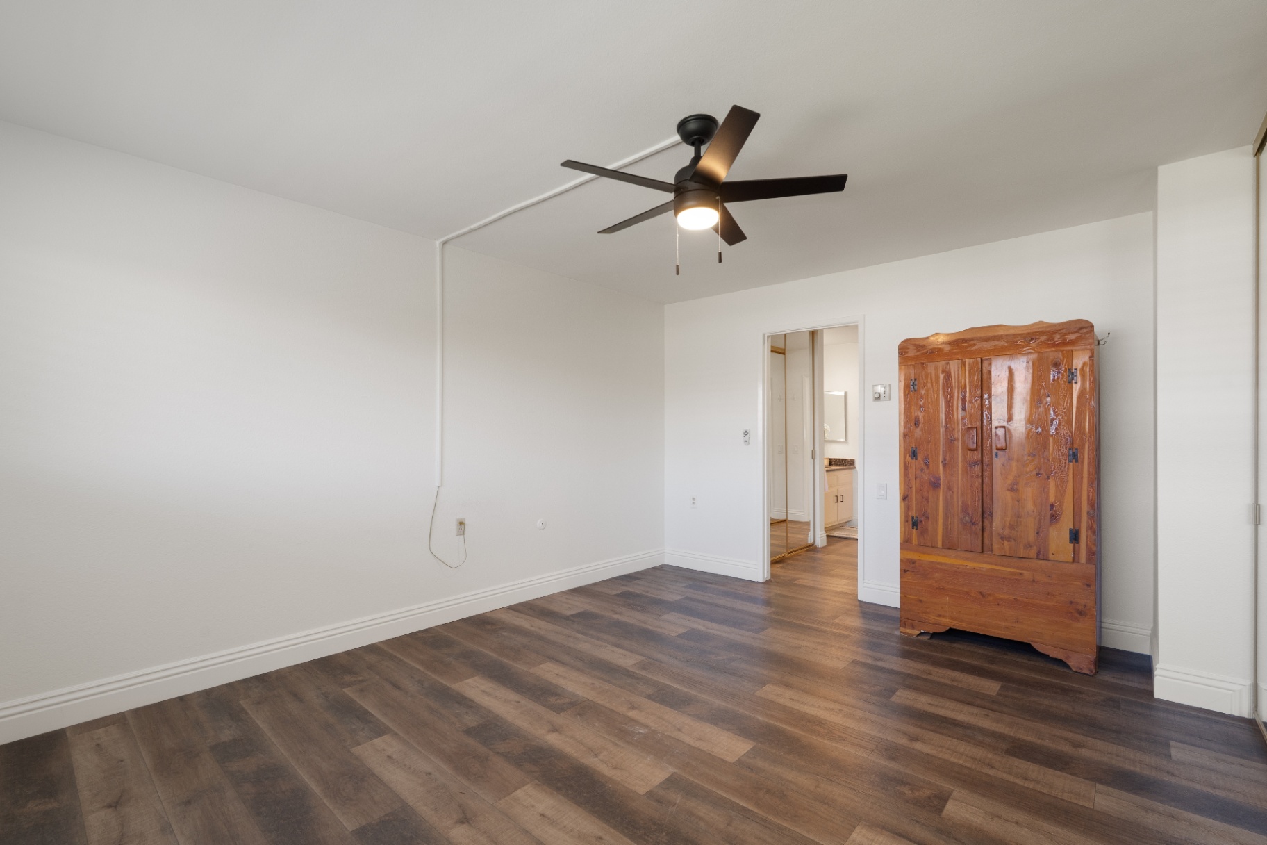 Second bedroom with vintage carved wood armoire