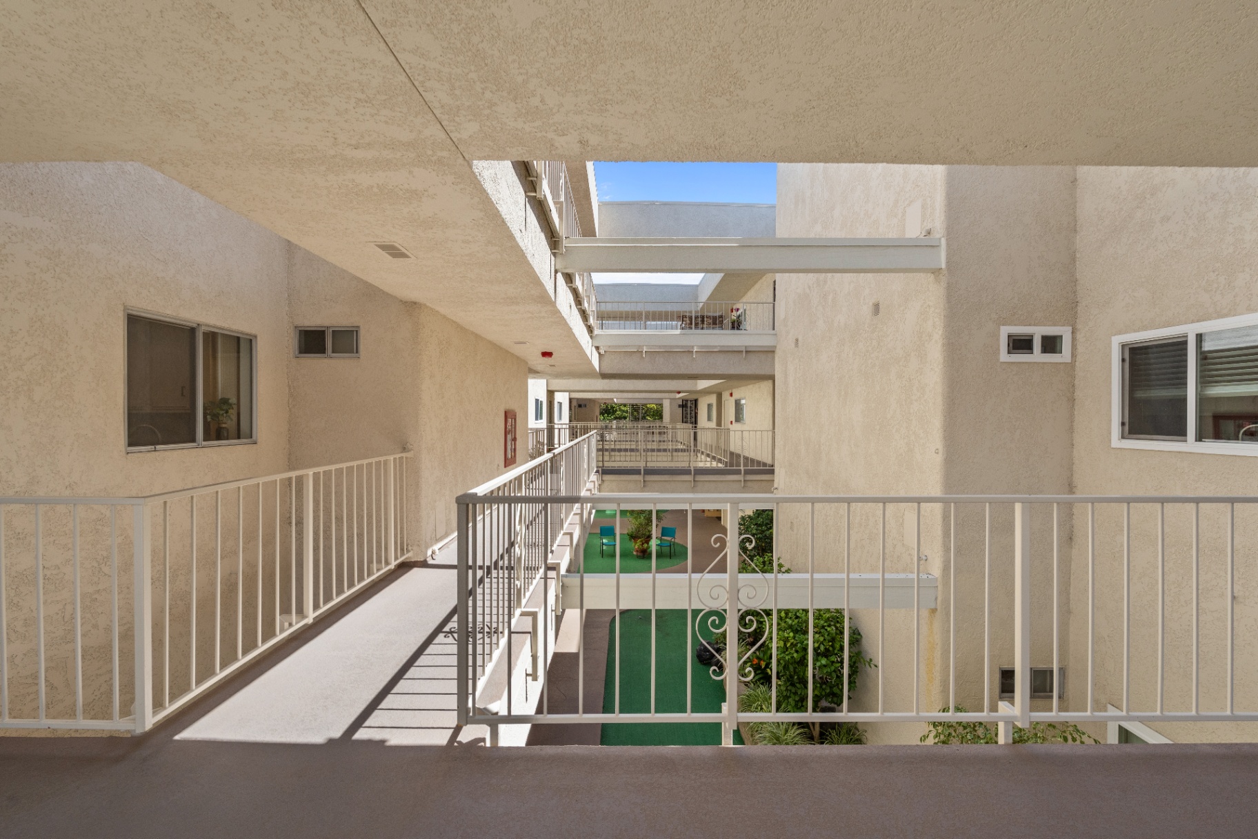 Second-floor exterior walkway overlooking the courtyard