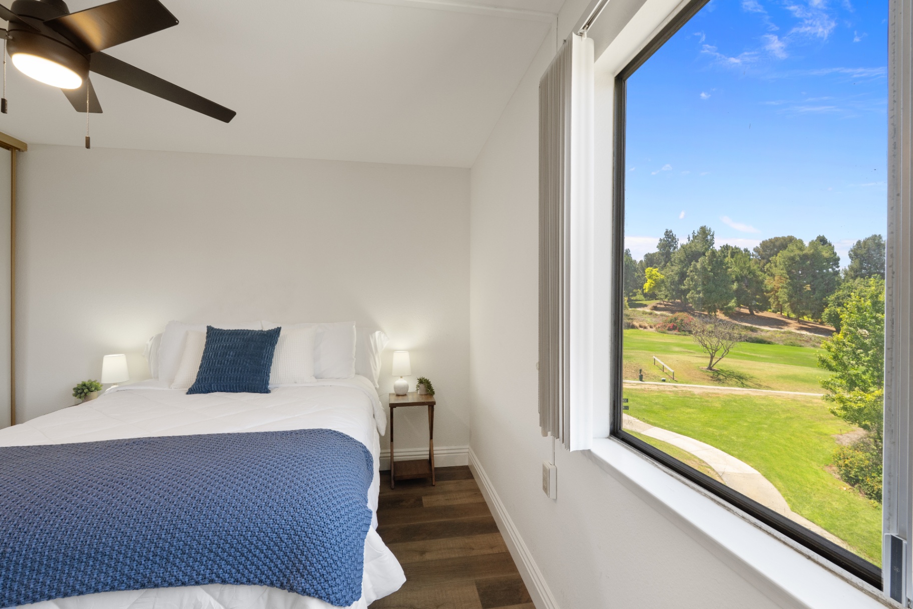 Primary bedroom looking out to the greenbelt and golf course
