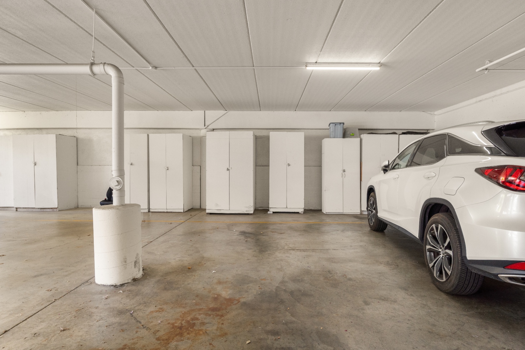 Assigned covered parking space with private storage cabinet