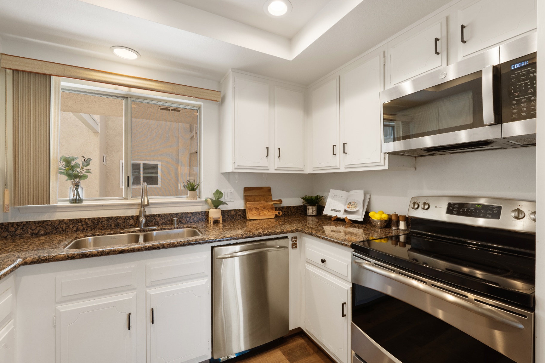 Kitchen with sink, dishwasher, and stainless electric range